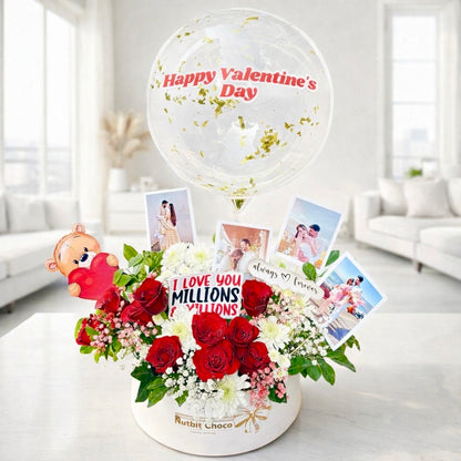 Valentine's Day arrangement with flowers, balloons, and photos in a modern living room.