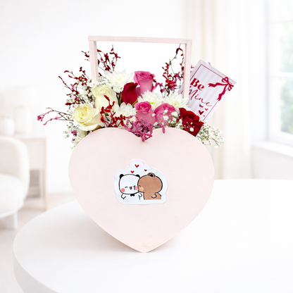 Heart-shaped box with flowers and a cute animal sticker on a white background