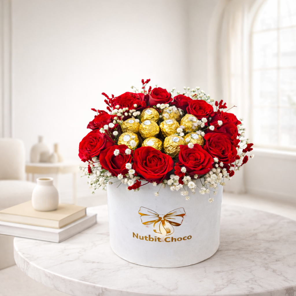 Bouquet of red roses and gold chocolate bars in a white box with 'Nutbit Choco' branding on a marble surface.