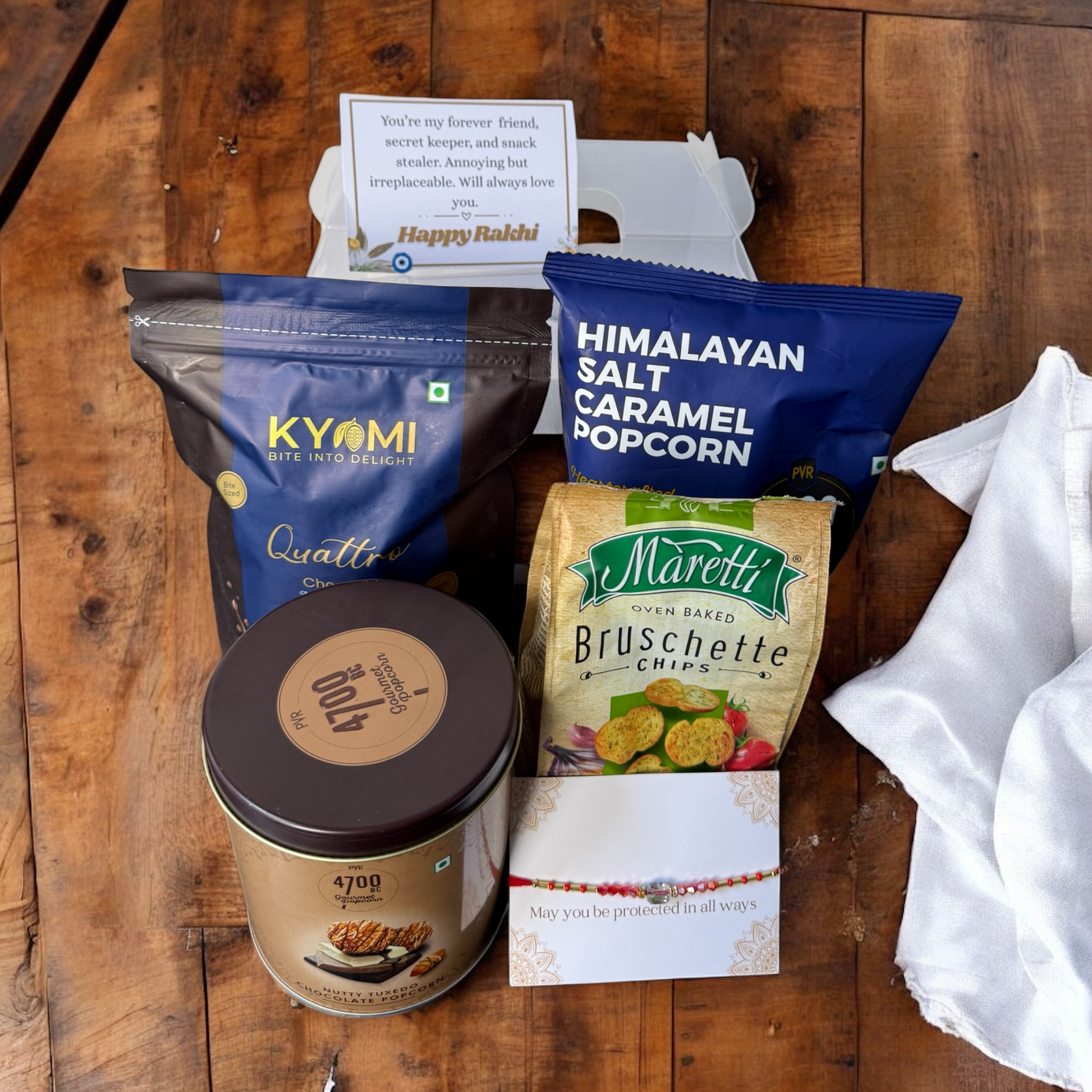 Assorted snacks and treats on a wooden surface with visible brand names.