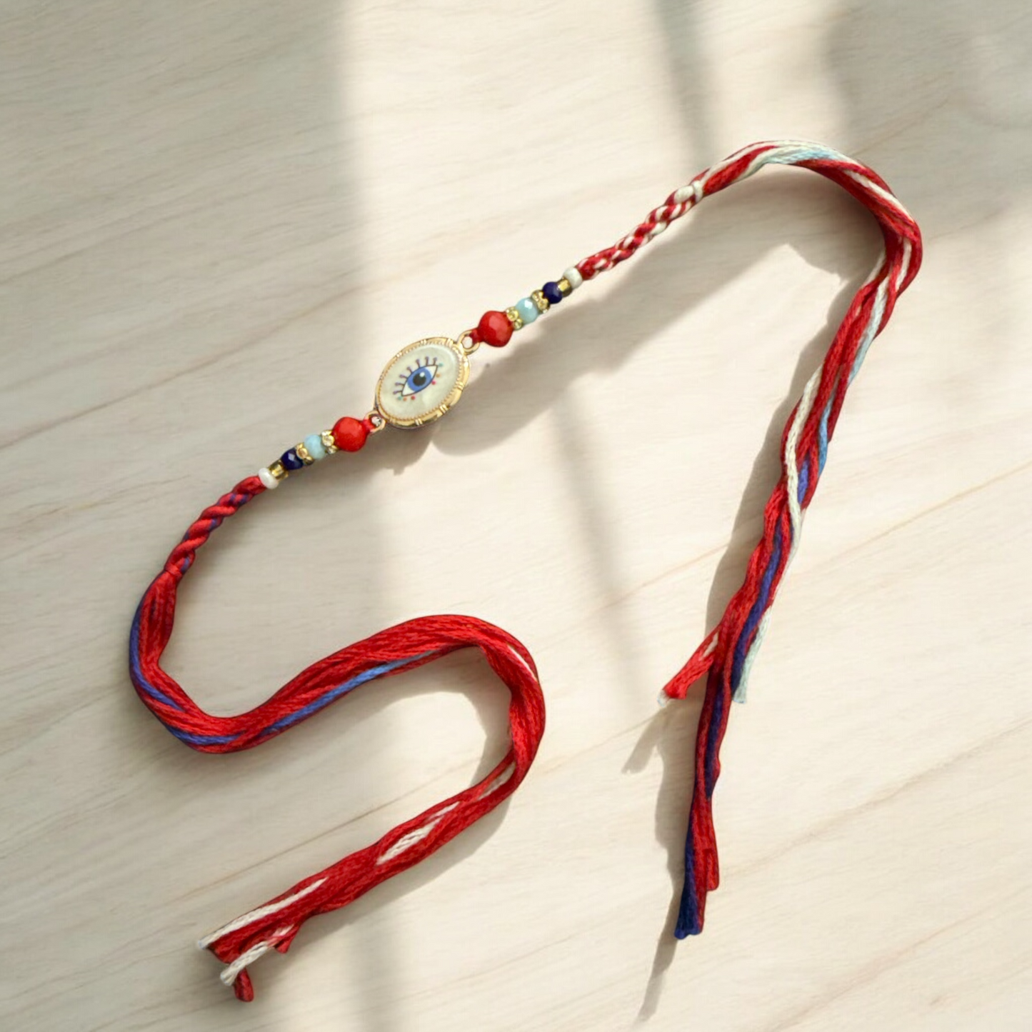 Colorful braided necklace with a decorative clasp on a light wooden surface