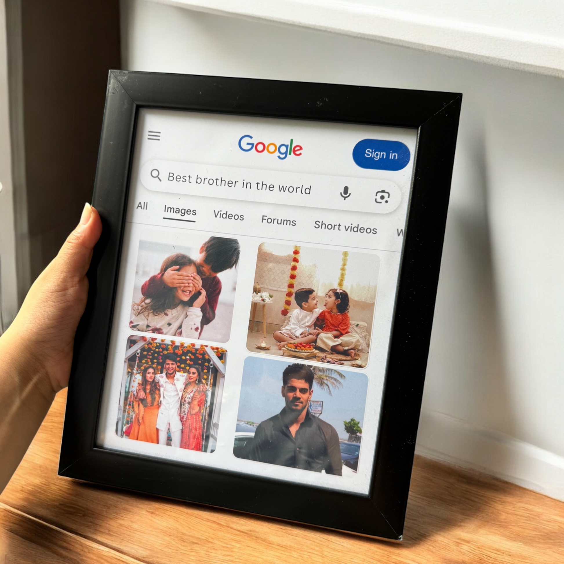 Digital photo frame displaying a Google search for 'Best brother in the world' with images of people.
